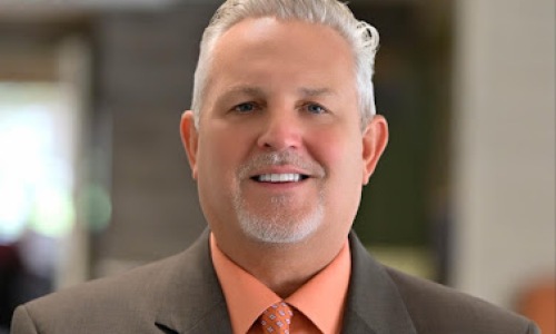 a smiling man in a suit